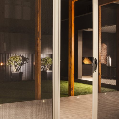 Amplimesh SupaScreen doors leading to outdoor deck area.